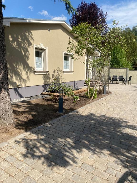a house with a tree in front of it at Villa Klitzeklein in Bad Belzig