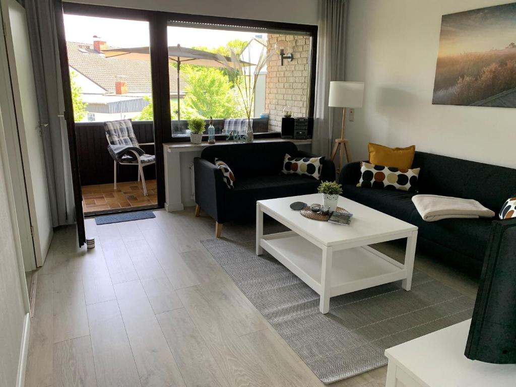 a living room with a couch and a table at Ferienwohnung Halvar in Maasholm