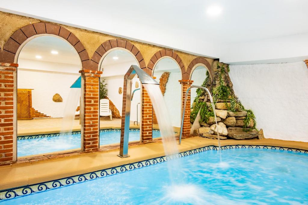 a pool in a hotel with a water park at La Chirumba in Aldeatejada