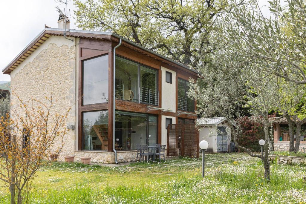 a house with a large window on the side of it at Masseria del Ponte in Pretoro