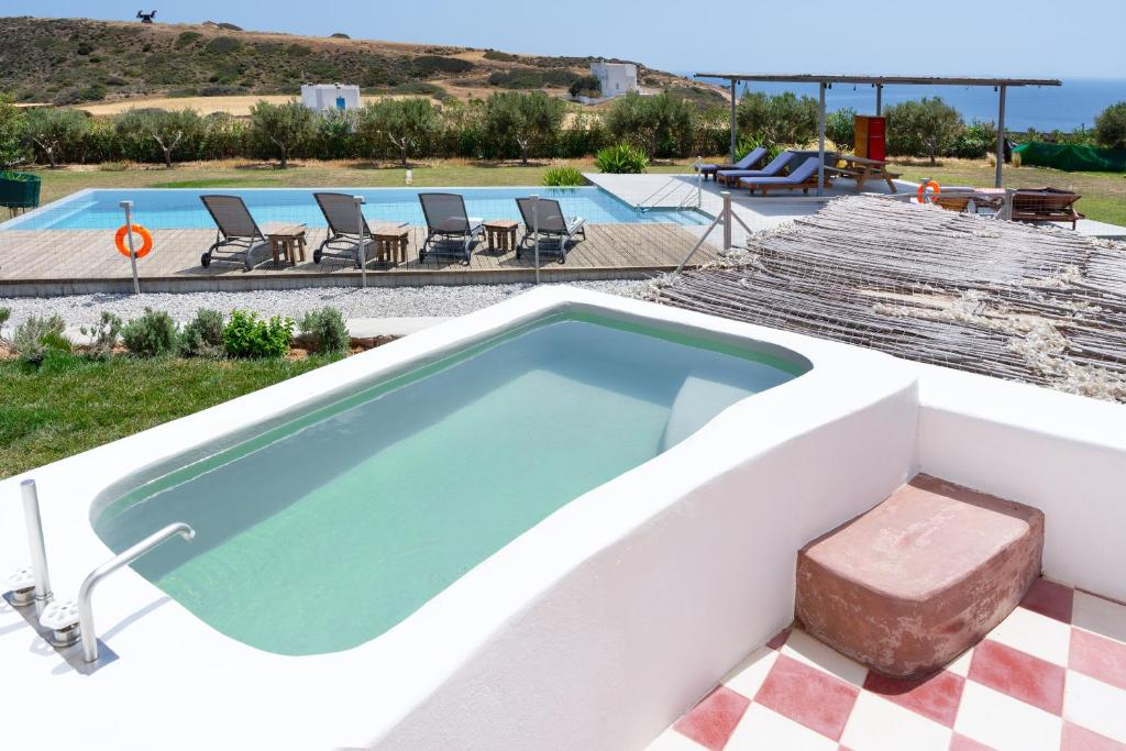 a pool with a hot tub on top of a house at Luna Rossa Milos - Chili Moon in Provatas