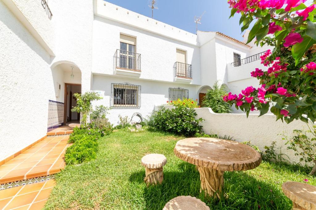 a garden with a table in front of a building at Casa Rural La Buganvilla in Níjar