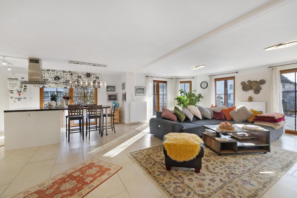a large living room with a couch and a kitchen at Feriendomizil Berta Benzingen 1 in Winterlingen