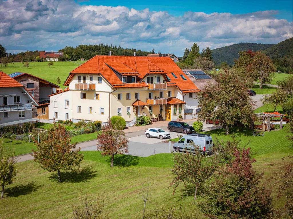 a large house with an orange roof in a village at Ferienhaus Bührer in Freiamt