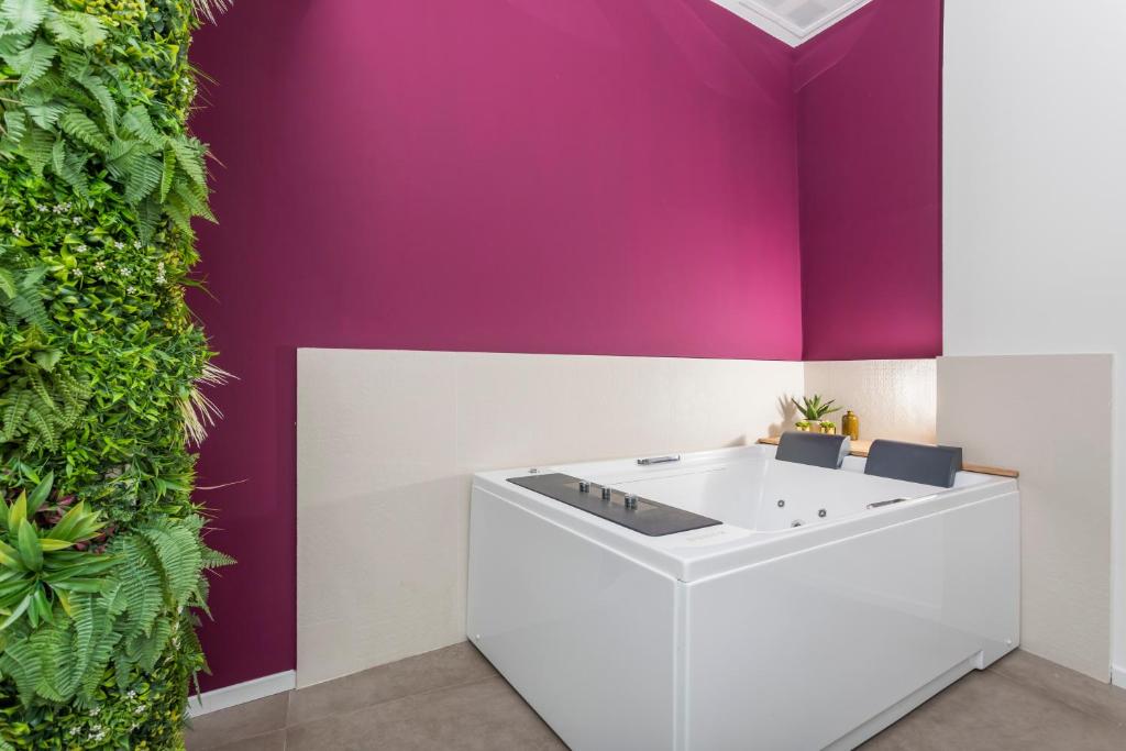 a bathroom with a purple wall at Taormina Center Suite with Jacuzzi in Taormina