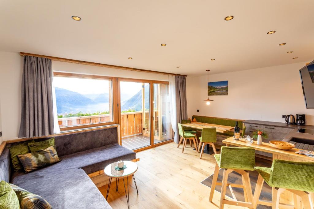 a living room with a couch and a table at Waldes Duft Apartment - Patleidhof in Naturno