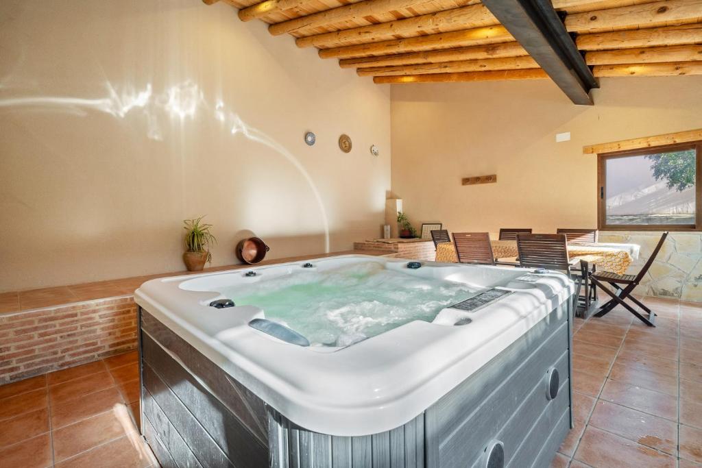 a jacuzzi tub in a living room at Torre Piquer in Berge