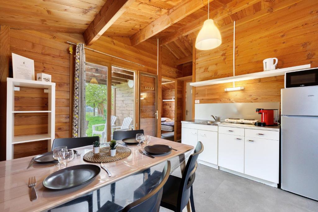 a kitchen and dining room with a table and chairs at Chalet confort 18 in Saint-Gervais