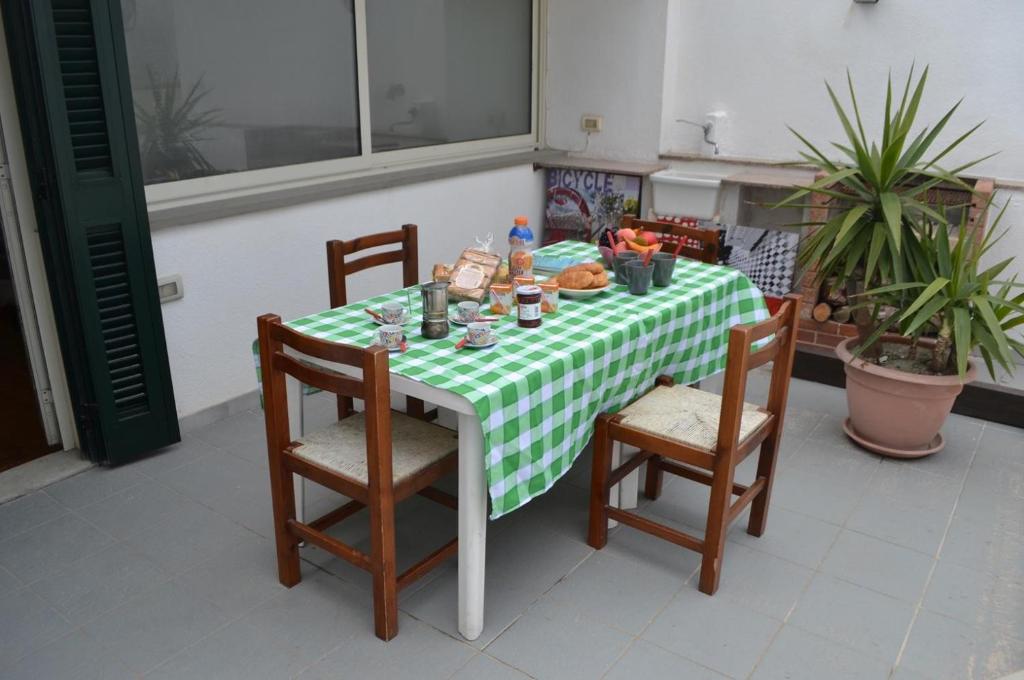 a table with a green and white checkered table cloth at Appartamento Ll06 a 60m dal mare in San Foca