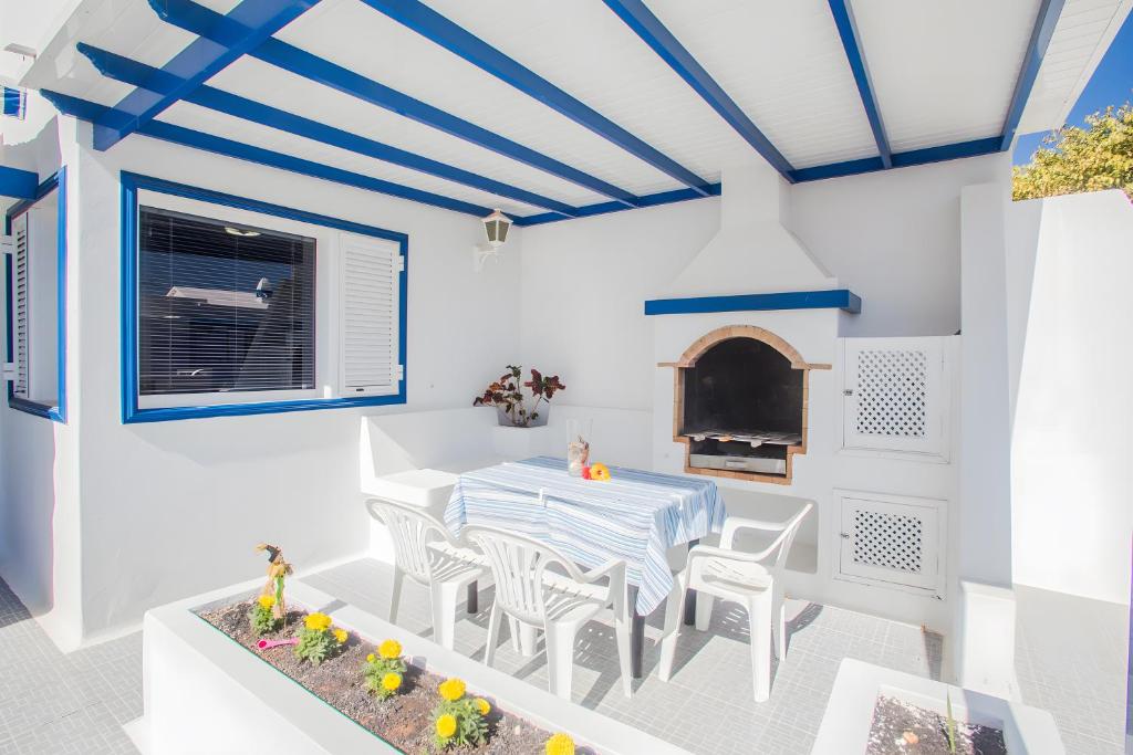 a dining room with a table and chairs and a fireplace at Villa Tabaiba in Haría