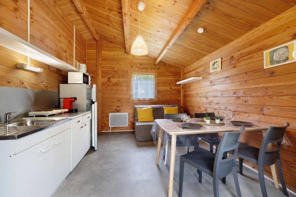 a kitchen and dining room with a table and chairs at Chalet confort 17 in Saint-Gervais