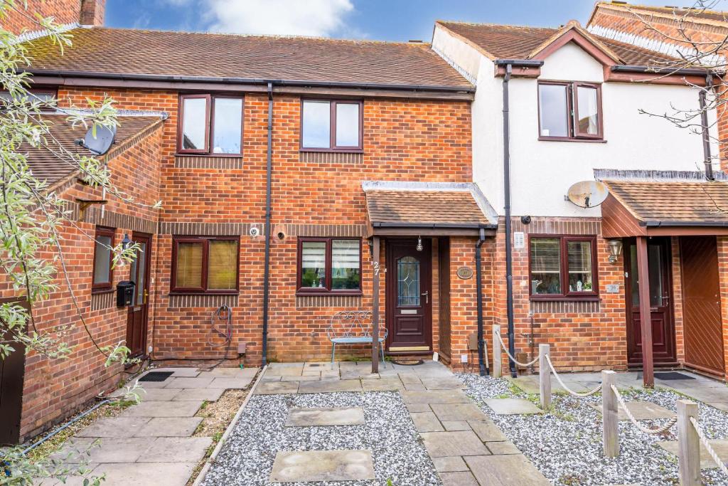 an exterior view of a brick house at Dolphin Cottage - Short walk to Poole Quay with Private Garden in Poole