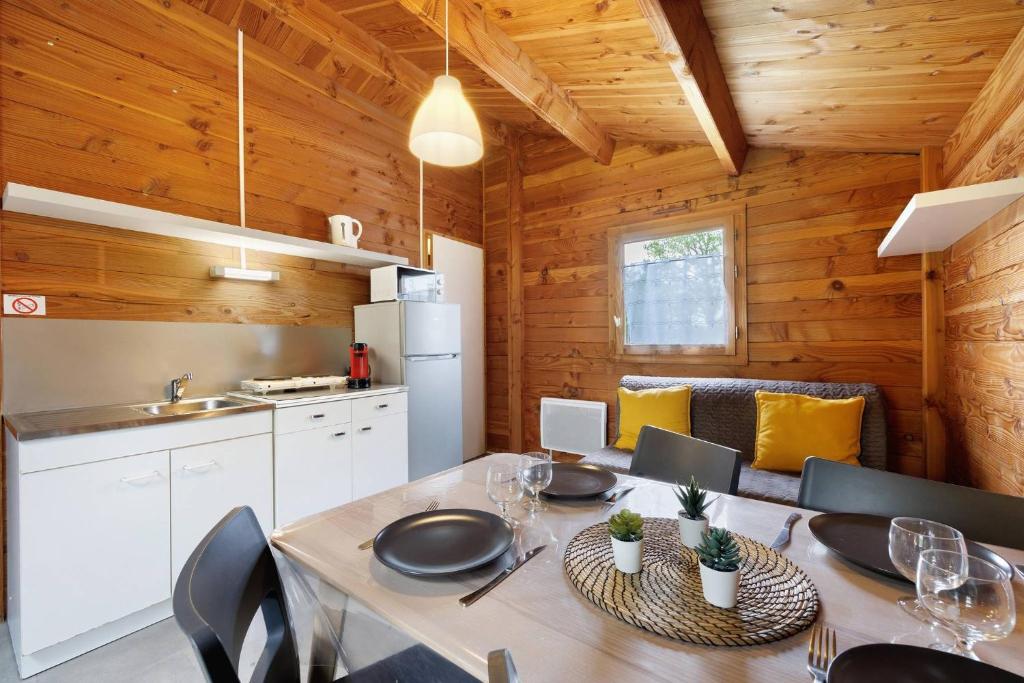 a kitchen and dining room with a table and chairs at Chalet confort 16 in Saint-Gervais