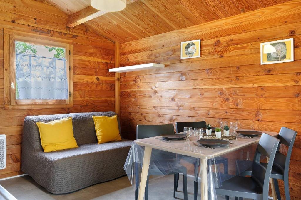 a dining room with a table and a couch at Chalet confort 14 in Saint-Gervais
