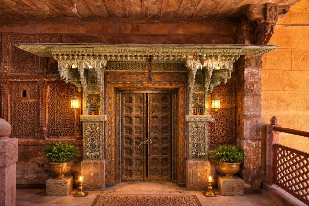 an entrance to a building with a wooden door at The Blue House in Jodhpur