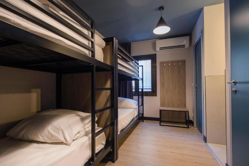 two bunk beds in a room with a hallway at Font Andorra Hostel by Nexta in La Massana