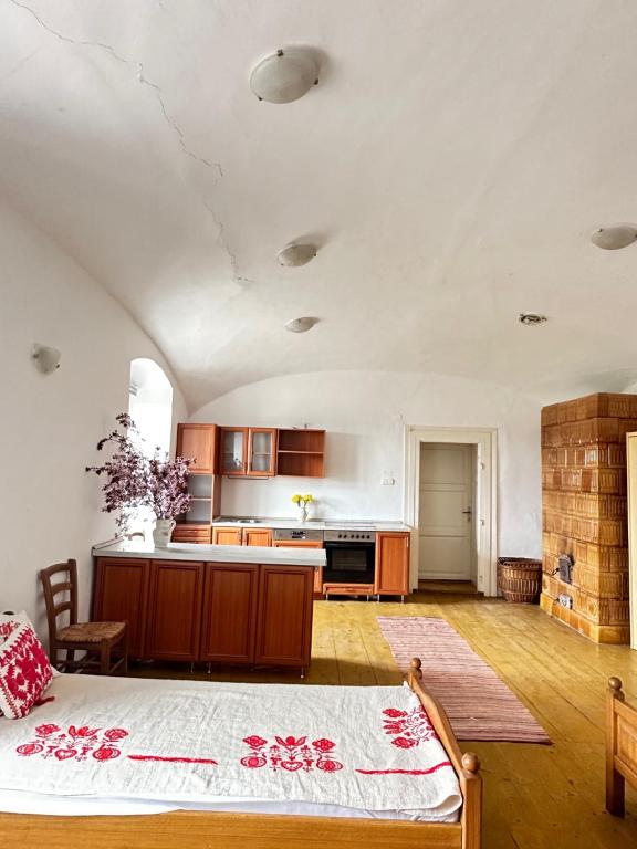 a large kitchen with a bed in a room at Stúdió apartman in Kővágóörs