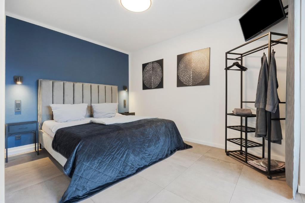 a bedroom with a bed and a blue wall at Egge Resort 7e mit Whirpool u Sauna in Altenbeken