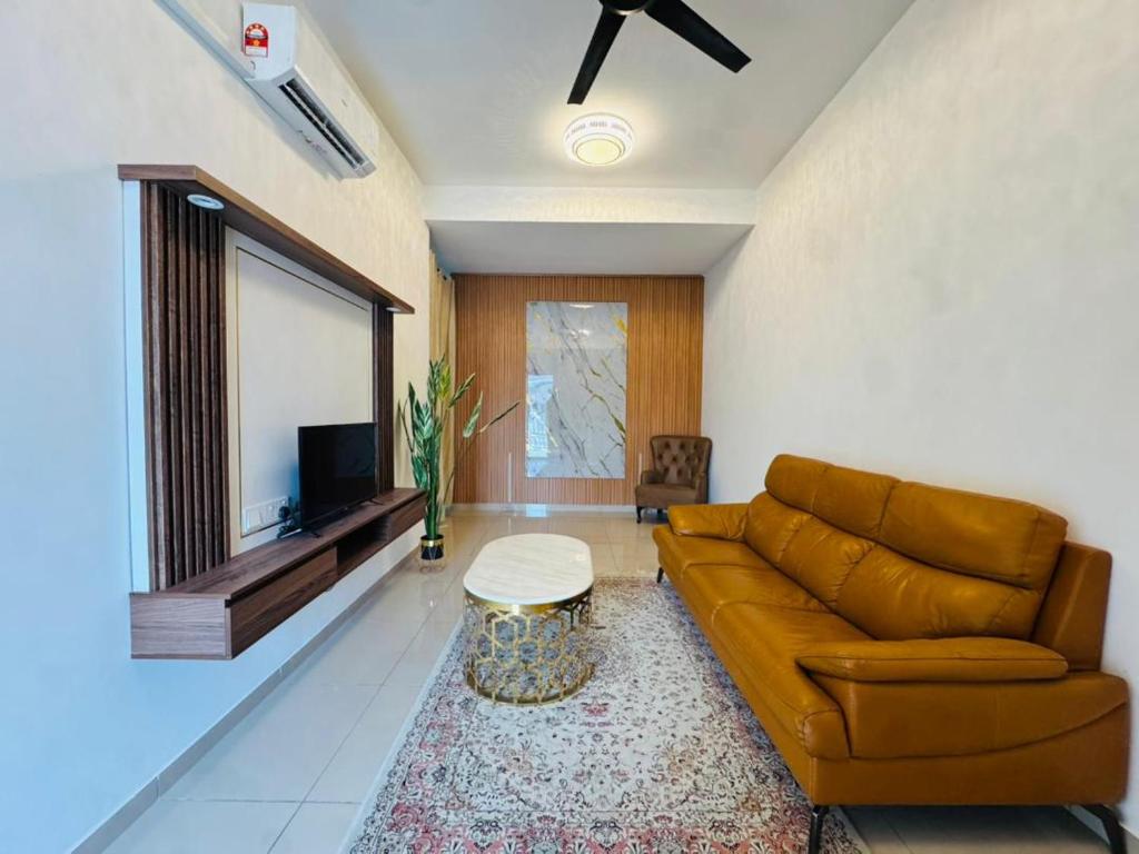 a living room with a couch and a tv at Pitstop Homestay Klia in Banting