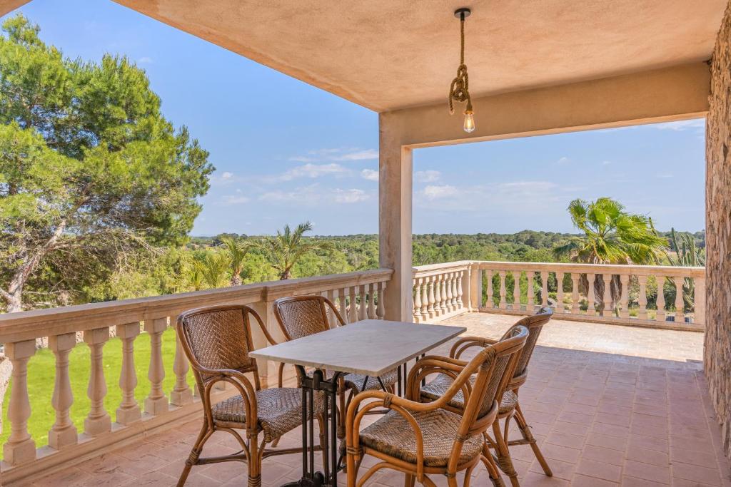 a patio with a table and chairs on a balcony at S'escodra in Llucmajor