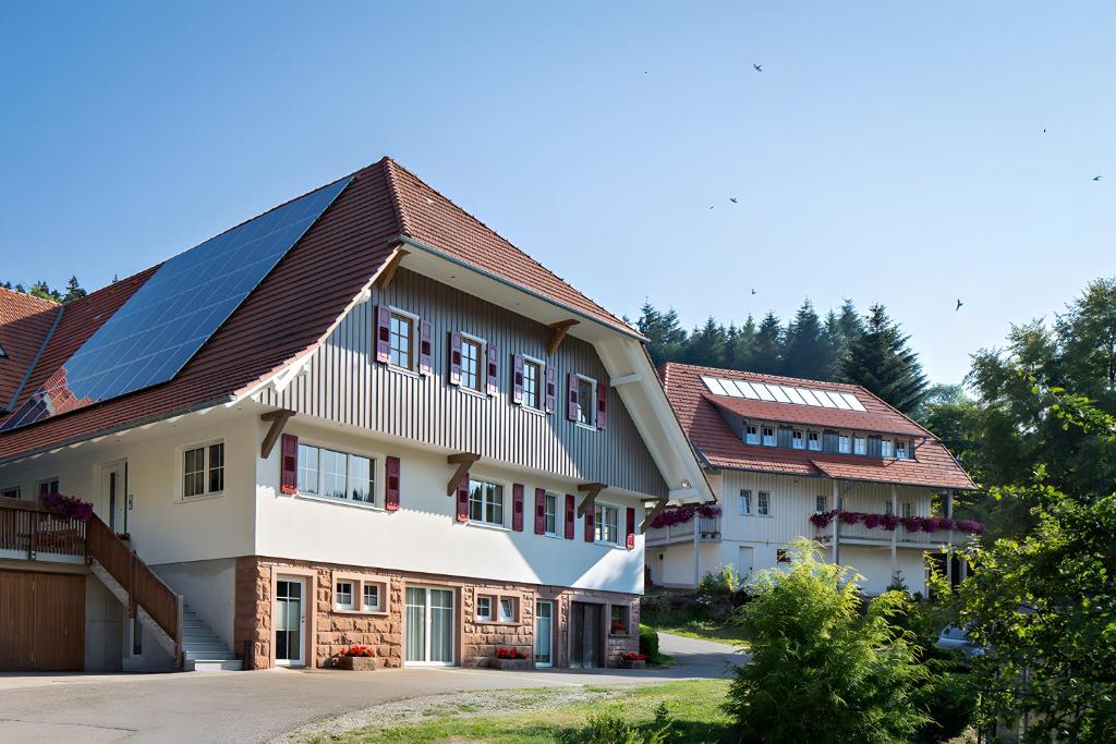 a house with solar panels on its roof at Schornhof in Oberwolfach