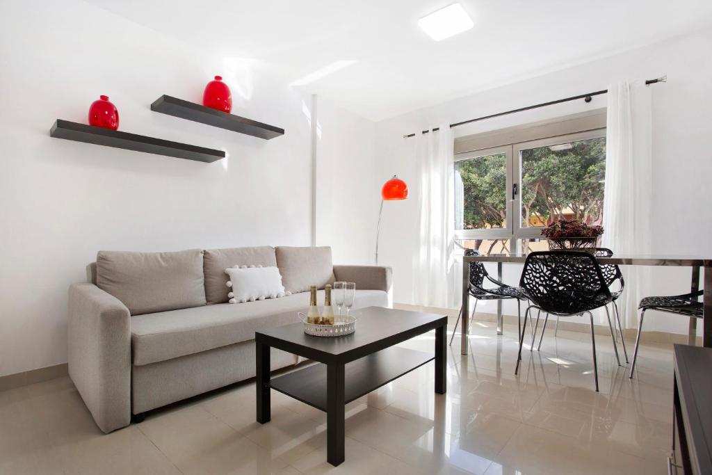 a living room with a couch and a table at Puerto Playa 2 in Puerto del Rosario