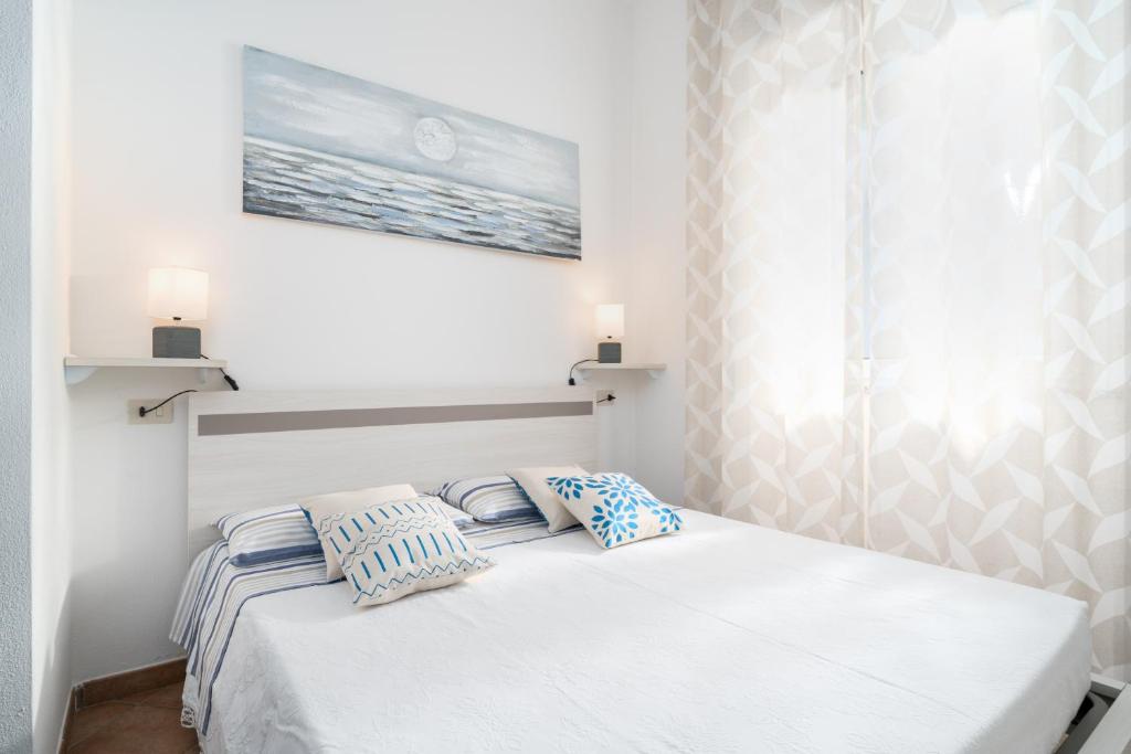 a bedroom with a bed with two pillows on it at Appartamento da Manzela 2 in Cala Gonone