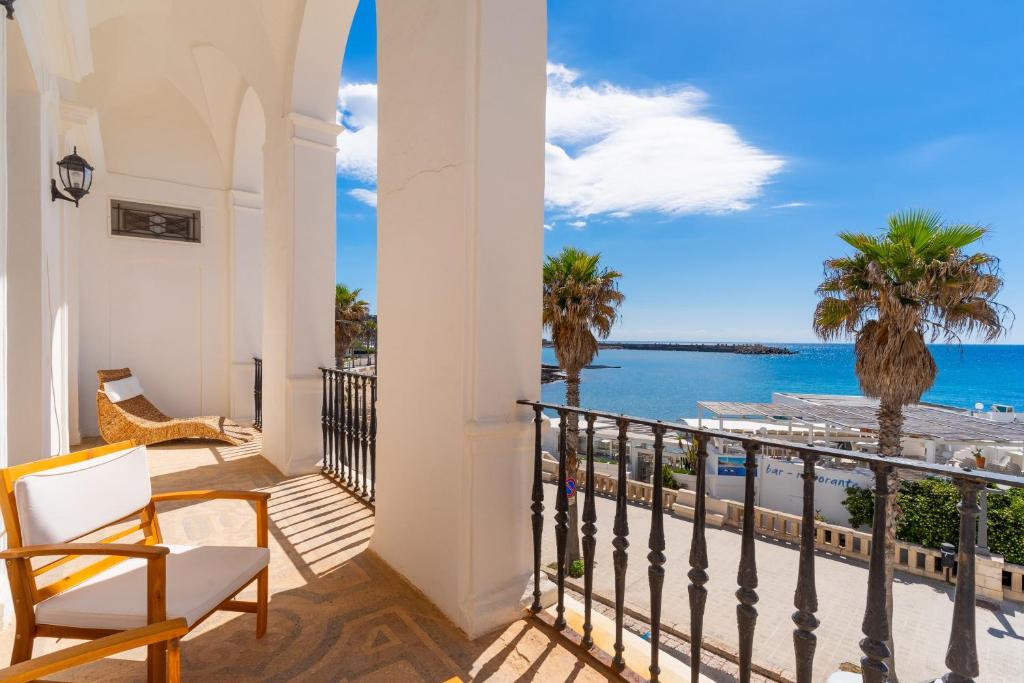 a balcony with a view of the ocean at Villa Ramirez in Leuca