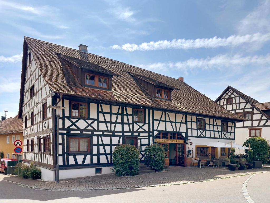 an old black and white building on a street at Villa Puppenhaus in Immenstaad am Bodensee