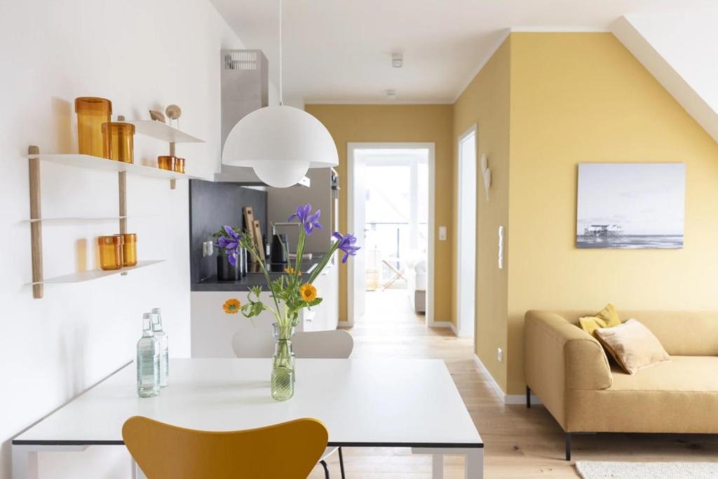 a living room with a table and a couch at Strandhafer in Böhl