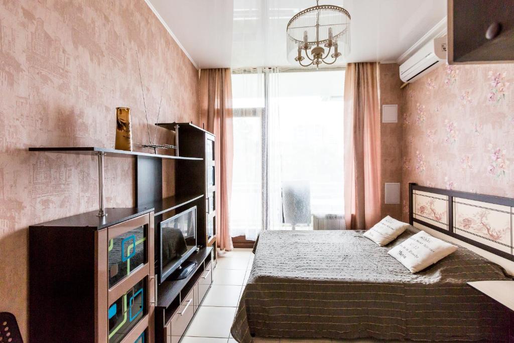 ソチにあるApartment Svetlana-Centerのベッド1台とテレビが備わる小さな客室です。
