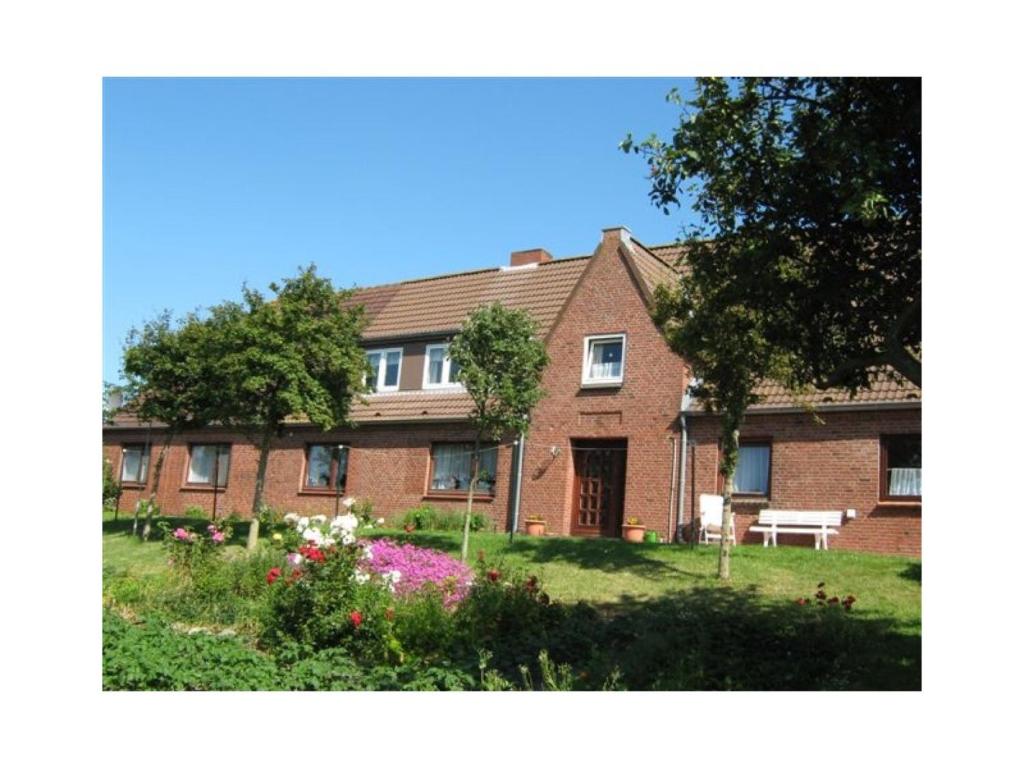 a brick house with a garden in front of it at Bauernhof Angelika Schulze Pellworm in Pellworm