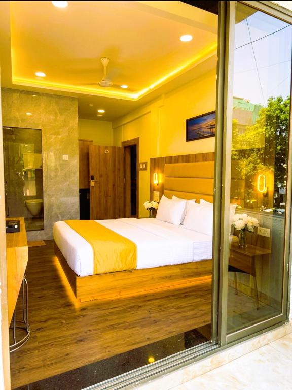 a bedroom with a large bed in a room at Hotel National - Grant Road in Mumbai