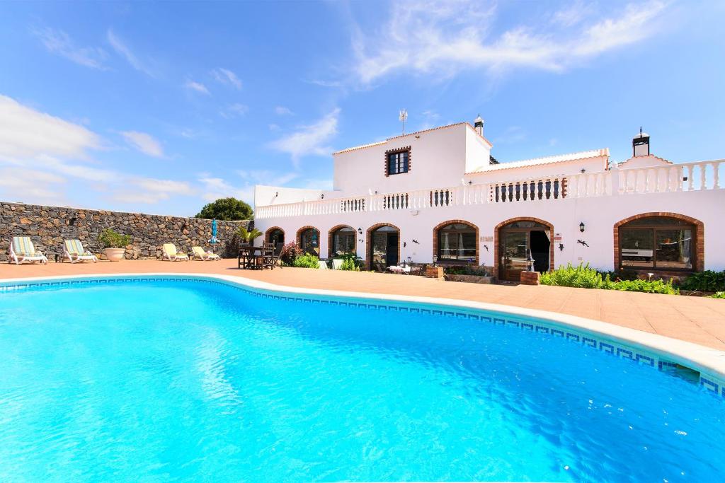 a large swimming pool in front of a house at Clara Suite 1 - Macaronesiahomes in Conil