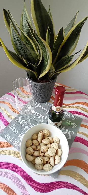 a bowl of nuts on a table with a plant at Fewo Nied in Rehlingen-Siersburg