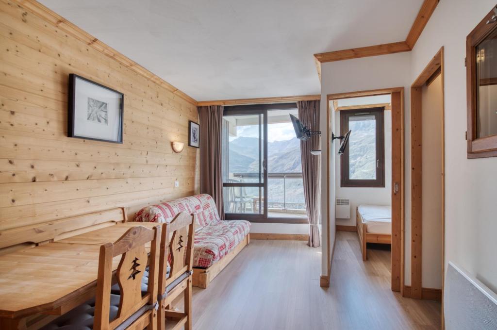 a living room with a couch and a table at Appartement N° 46 in Les Menuires