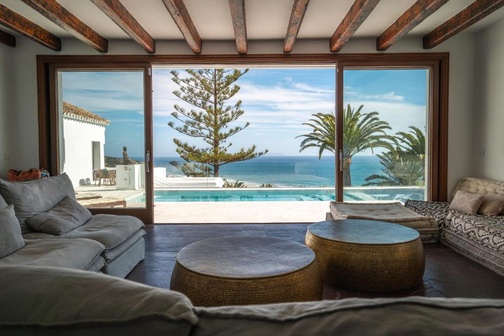 a living room with a view of the ocean at The Cube in Zahara de los Atunes