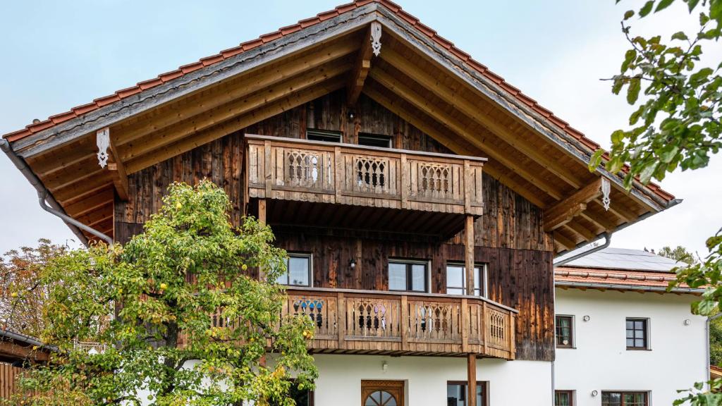 a wooden house with a balcony on top of it at Wohnung Staufenblick in Freilassing