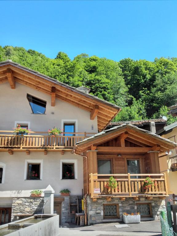 a large wooden house with a balcony at Maison Olga in Valtournenche