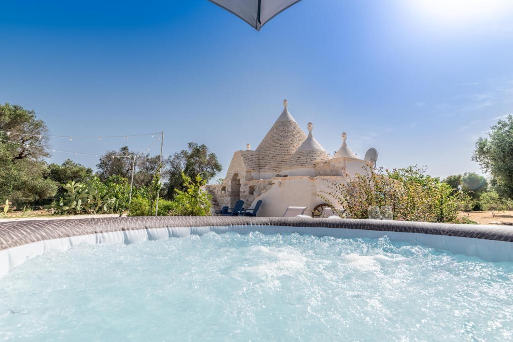 a swimming pool in front of a house at Il Trullo di Mariangela in Ceglie Messapica