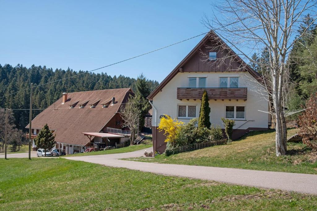 a house and a barn with a road at Unterfalkenhof in Schramberg