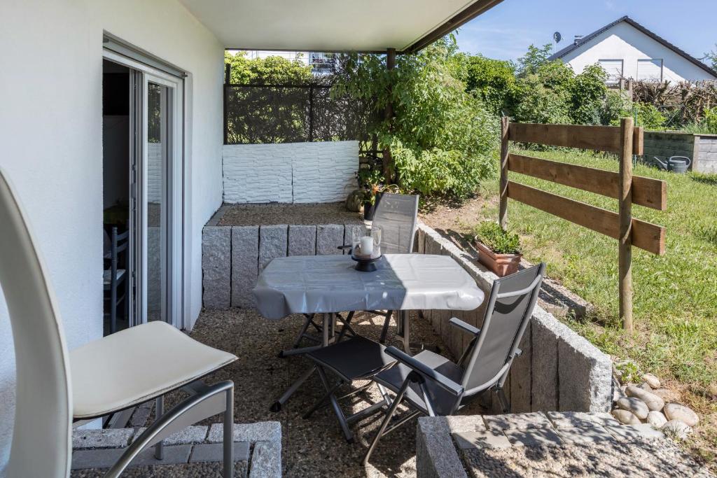 a small patio with a table and chairs on it at Ferienwohnung am Bregenberg in Bräunlingen