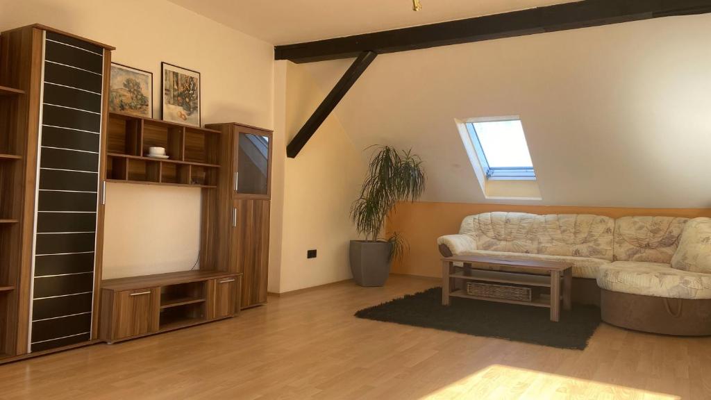 a living room with a couch and a table at Wohnung an der Galopprennbahn in Iffezheim