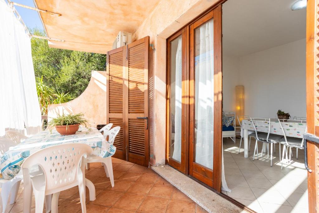 a dining room with a table and chairs on a patio at Casa Orimar 419 in Badesi