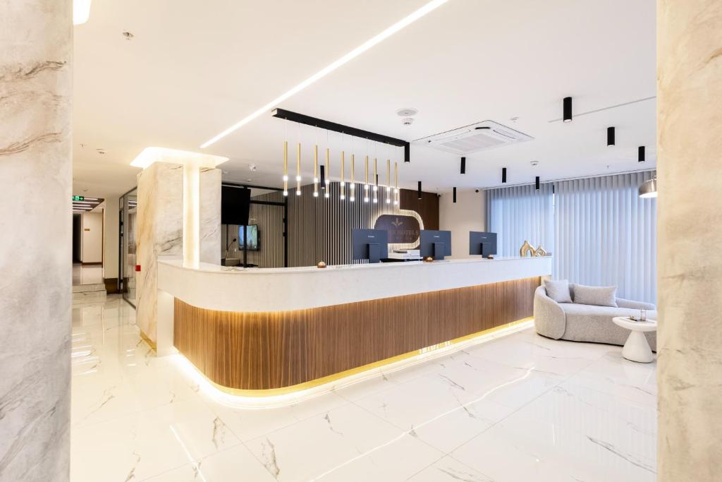 a lobby with a reception counter and a chair at Avwan Hotels Collection in İzmir