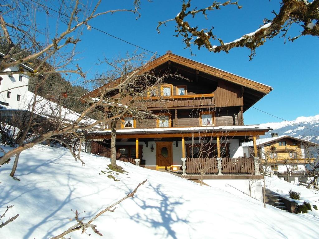 a house on top of a snow covered slope at Alpenchalet Bergprinzessin in Mühlen