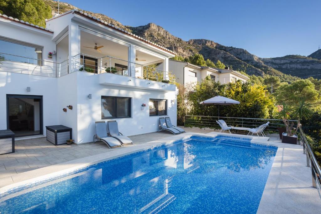 a villa with a swimming pool and a house at Mountain View Villa in Bárig