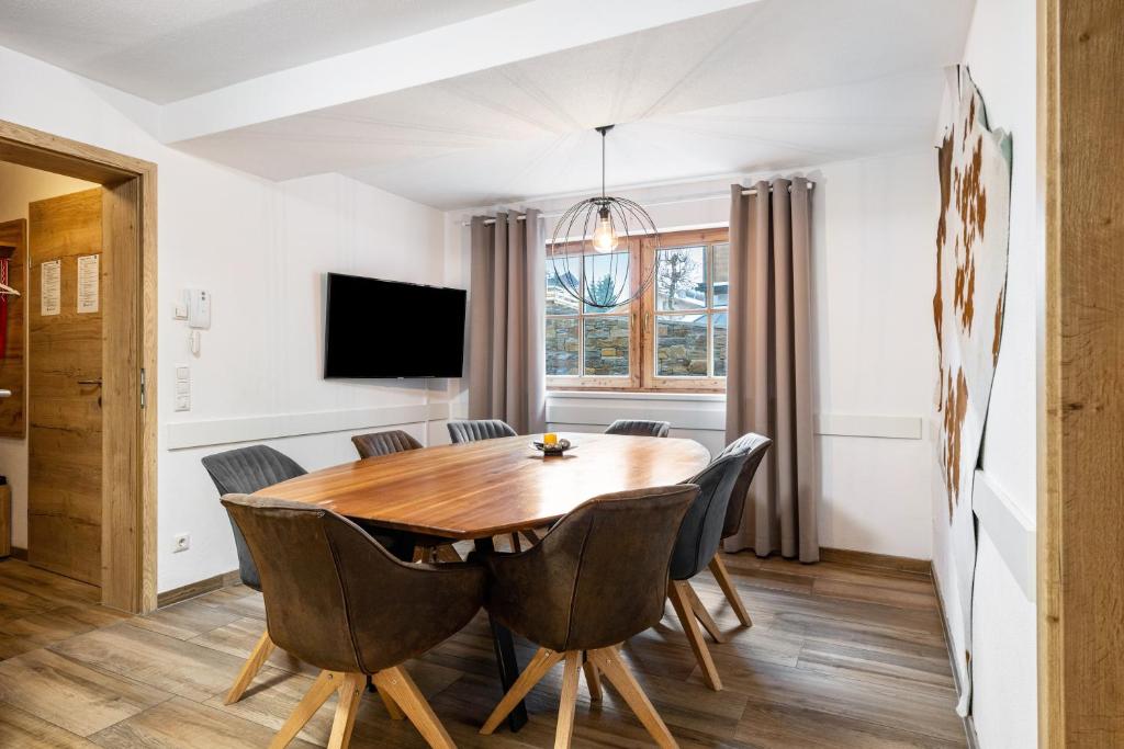 a dining room with a wooden table and chairs at Good Life Top 3 in Saalbach-Hinterglemm