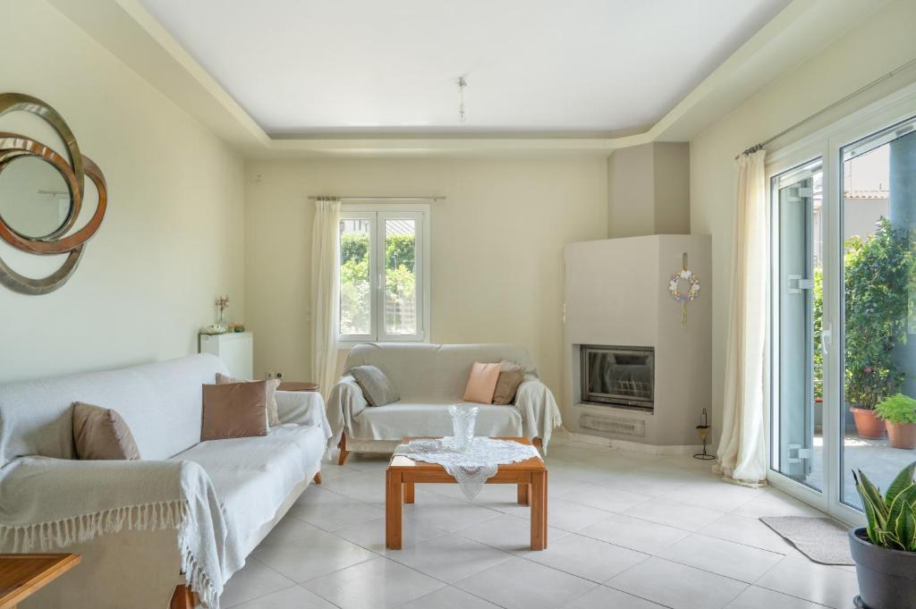 a living room with a couch and a table at Elia home kanali in Kanali
