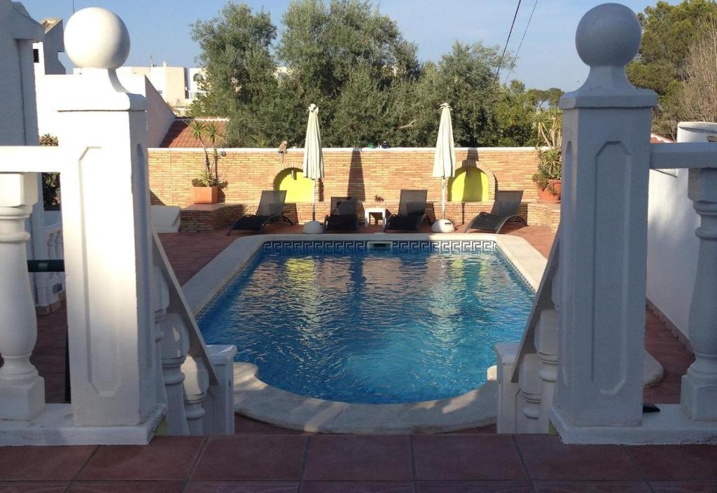a swimming pool in a backyard with a white house at Villa with private pool - near golf in San Miguel de Salinas